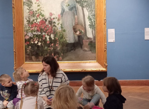 Grupa dzieci i animator na tle obrazu