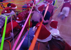 Dzieci przechodzą pod pajęczyną wykonaną z kolorowych